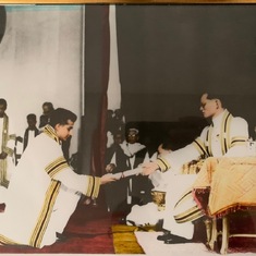 Receiving his college degree from the King of Thailand