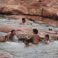 Floating down the chute at slide rock in front of his friends and dad. 7th grade