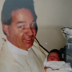 Dad, holding his first born grandchild. Monica Leigh Dennewitz, 1989