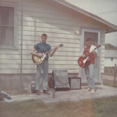 Jack, Jim playing guitars on porch