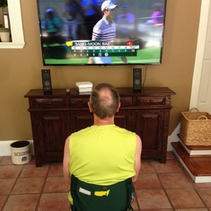 Watching golf!  Sitting on his fold up chair from The Masters