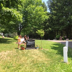 Watering daddy's flowers and cleaning his headstone.