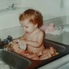 Giving her baby a bath in the kitchen sink, lol.