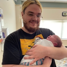 Brandon Hatcher holding his son Ody