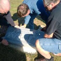 Scott, Gerald, and uncle Randy putting there gravestone down