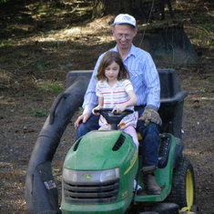 Dad letting Josie ride the mower.  He's clearly having a great time