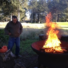 Jimmy using the fire pit next door to his house in Ocean Shores
