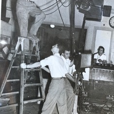 Mr Baker at KLAC TV hold ladder while somebody else does the work.!The man on Jims right should is Mal Klein later GNI of KFI in LA. At the light board Bill Cogan who took pic at Jim and Julies wedding in SF