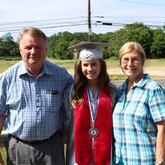 Jim with his wife and one of his granddaughters, Kira, at her high school graduation.