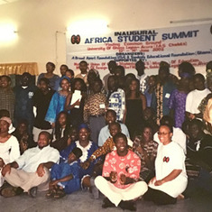 From Debra B: JR sitting on the floor left, I'm also on the floor right side with glasses, white t-shirt red/black log.  The Summit held  was in Ghana June 2003 at a Pan African Student Summ