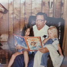 Grandpa reading to granddaughters Dana and Kristy