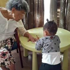 Grandma teaching Chloe how to write 
