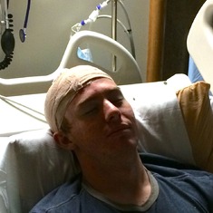 bandages back on after procedure to remove fluid buildup under his scalp