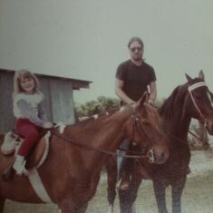 Jenna on her horse riding with her dad