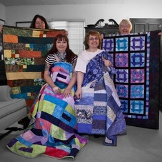 Jennie, Kak, Mom and Em with our "Auntie Kathi" quilts.
