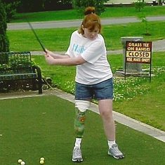 Jen showing her swing with her new Pooh leg for a benefit for Hangar