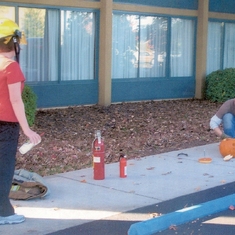 Jennie and Todd blowing up a pumpkin at work