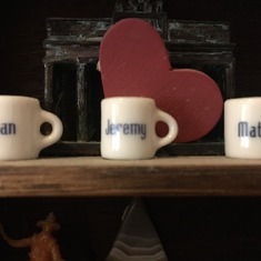 Miniature mugs in Mary's shadowbox.