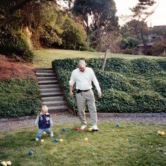 Teaching Aaron golf in the backyard