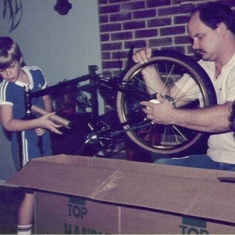 Me, Dad, and Justin putting together a bike