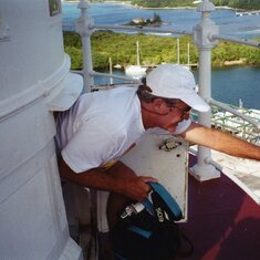 1996:  Jim crawling out the top of the light house.  Note camera in his right hand, always ready for action.