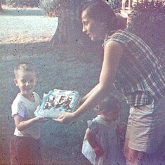 Mom showing Ed his birthday cake
