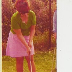 joan trying to play  golf