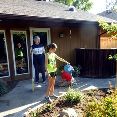 Carley & Carter planting and watering flowers in Nona's garden. Fresno, CA