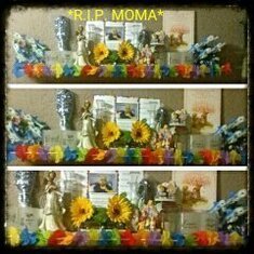 my moma's shrine..theres her pik the only one i have might i add ashes glasses hairbrush hairties angels n dolphins .. still got alil more to add to her shrine but i think so far so gud .. im sure she'd like it