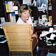 Joan working at her desk at home with her helper