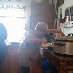 Mom carving the bird and a couple doggies inline for a treat.