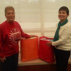 Mom helping Jenny make a donation from Sow Many Blessings at Kishwaukee Cancer Center.