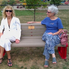 Joanne and Leora sitting on the bench at the JCC to honor their father