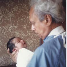 John holding Ravi after birth