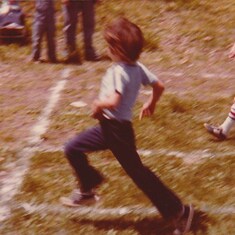 John at school running a relay race