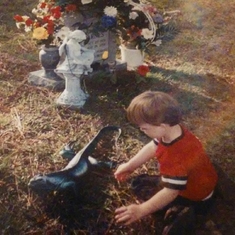 Ashton at his dad's grave site deciding where to put spike