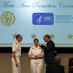 John placing shoulder board on Shauna when promoted to Commander in the U.S. Public Health Service.