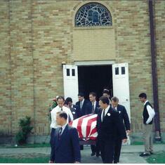 The casket leaving the church.