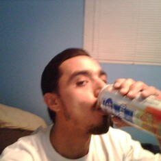 John drinking a chela/his favorite. He took this of himself with his celphone. My silly son.