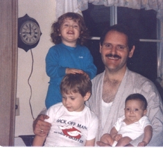 John as a young Dad, with Matt, Katie, and baby Rachel 1985.