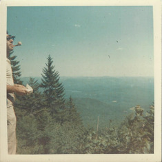 Dad looking out over the vista from Mt. Chocoura during a family day hike while vacationing at Lake Winnipesaukee in the summer, probably 1965. Note his white and yellow meerchaum pipe of which he was rather proud.