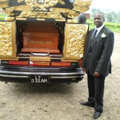 Ernest Sama with the hearse and casket outside the church