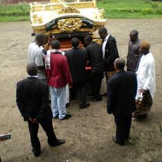 Removing casket from the hearse at the church