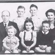 John (bottom right) and his family