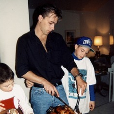 1992.John Carving Turkey at his mom's house, with Blaine (left), and CJ (right.) -- Jeanne's boys.