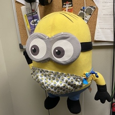The minion i got him with his minion mask on it hanging in his office