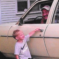 John and his grandson Zane having fun with "The Old Navy Car" also know as Granny Carter's '77 Nova.