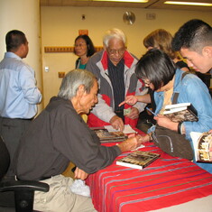 John signing books with the ESL students