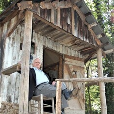 John on porch of tiny one-room shack once owned by Union County musician Tom Cassidy