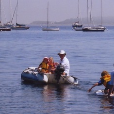 Dinghy towing the surfers